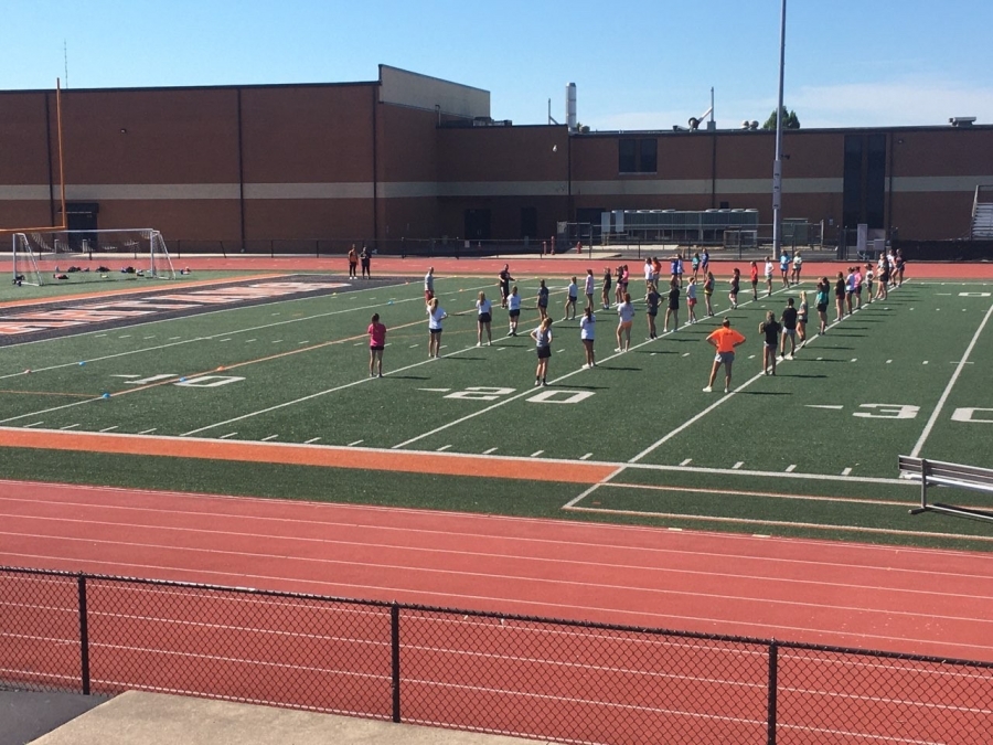 image of people on a track and field